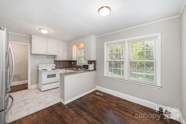 kitchen with stainless steel refrigerator, white cabinetry, sink, white electric stove, and light hardwood / wood-style floors