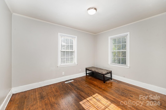 unfurnished room with ornamental molding and hardwood / wood-style flooring