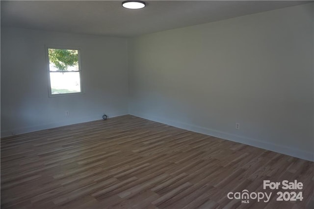 empty room with dark wood-type flooring