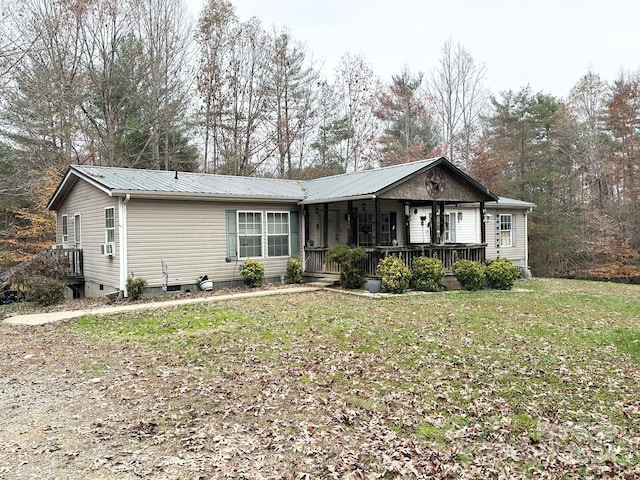 ranch-style home with a front yard and covered porch