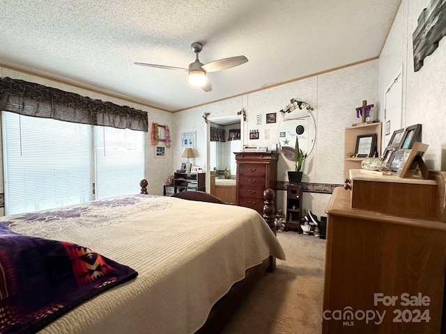 carpeted bedroom featuring a textured ceiling, ceiling fan, and crown molding