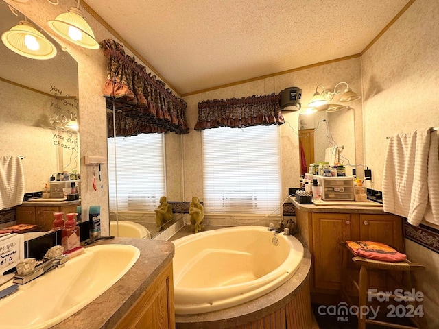 bathroom with ornamental molding, a washtub, vanity, a textured ceiling, and lofted ceiling