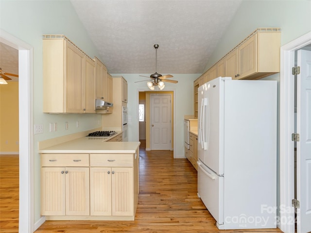 kitchen with ceiling fan, light hardwood / wood-style floors, a textured ceiling, lofted ceiling, and white appliances