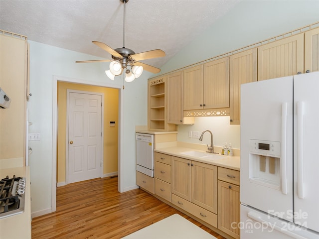 kitchen featuring light brown cabinets, white appliances, sink, vaulted ceiling, and light hardwood / wood-style floors