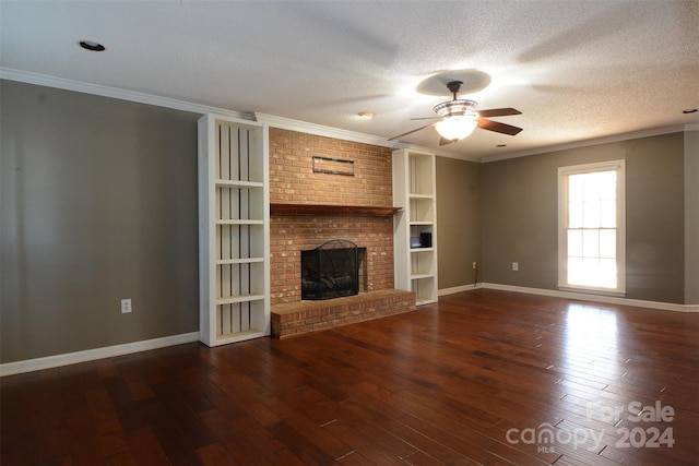 unfurnished living room with dark hardwood / wood-style flooring, a brick fireplace, ornamental molding, a textured ceiling, and ceiling fan