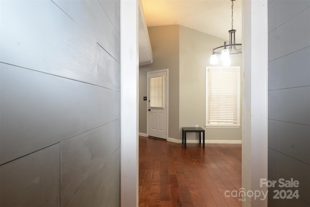 corridor featuring dark hardwood / wood-style flooring and vaulted ceiling