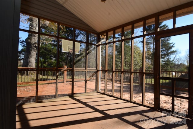 unfurnished sunroom with lofted ceiling