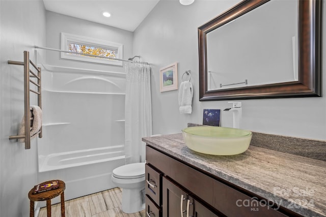 full bathroom with vanity, shower / bath combo, and toilet