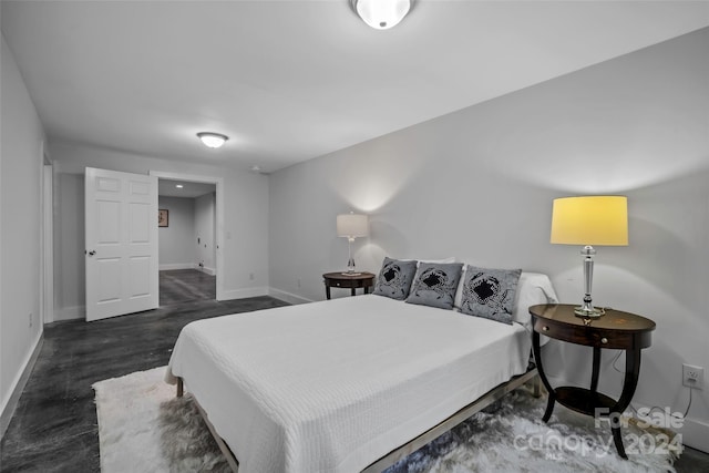 bedroom with dark hardwood / wood-style floors