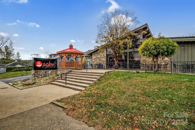 view of home's community with a gazebo and a lawn