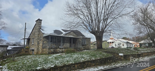 view of property exterior with a sunroom and a yard