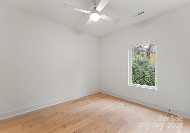 spare room featuring light hardwood / wood-style flooring and ceiling fan