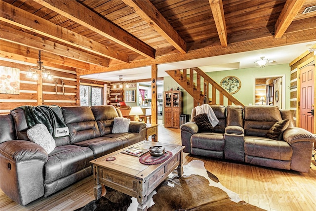 living room featuring a chandelier, hardwood / wood-style floors, and beam ceiling