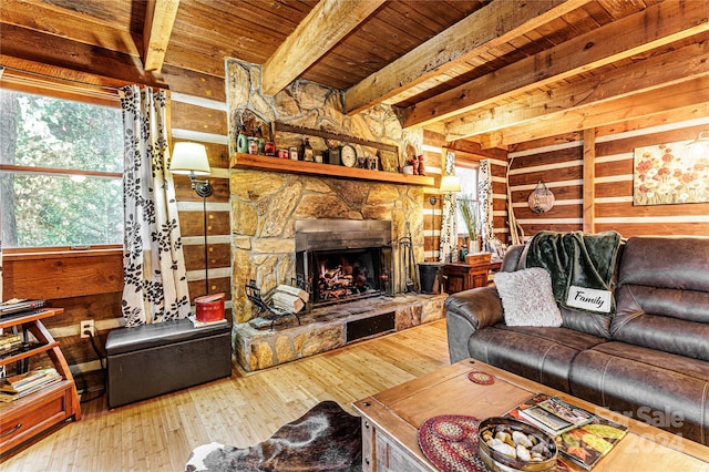 living room with beamed ceiling, wood-type flooring, a fireplace, and wooden ceiling