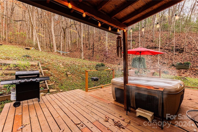 wooden deck featuring a hot tub