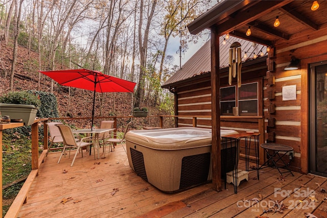 wooden terrace featuring a hot tub