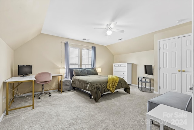 carpeted bedroom with ceiling fan, a closet, and lofted ceiling