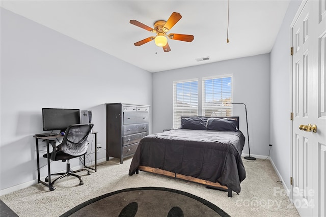 bedroom with ceiling fan and light carpet