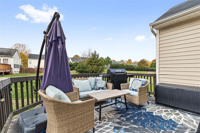 deck with an outdoor hangout area and grilling area