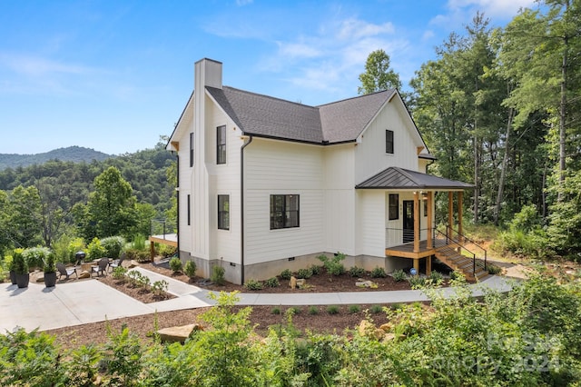 exterior space with a mountain view and a patio area