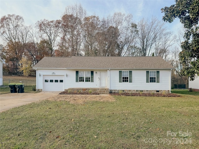 single story home with a garage and a front lawn