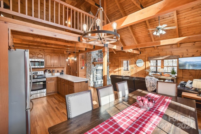 dining room featuring ceiling fan with notable chandelier, wooden walls, beam ceiling, light hardwood / wood-style floors, and wood ceiling