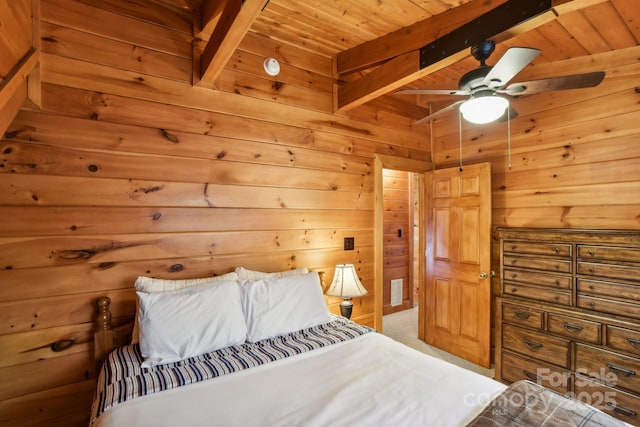 bedroom with beam ceiling, carpet floors, wooden ceiling, and wood walls