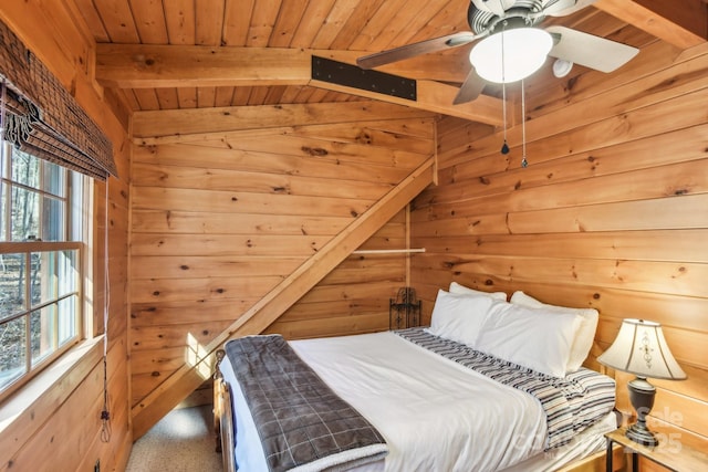 bedroom with beamed ceiling, wood ceiling, and wooden walls