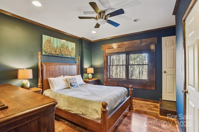 bedroom featuring crown molding, dark hardwood / wood-style floors, and ceiling fan