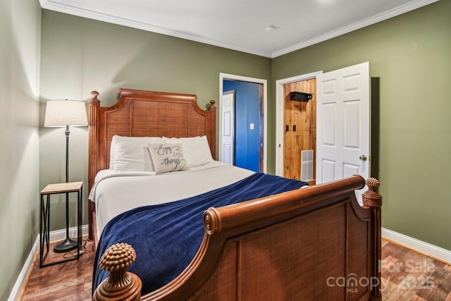 bedroom with hardwood / wood-style floors and ornamental molding