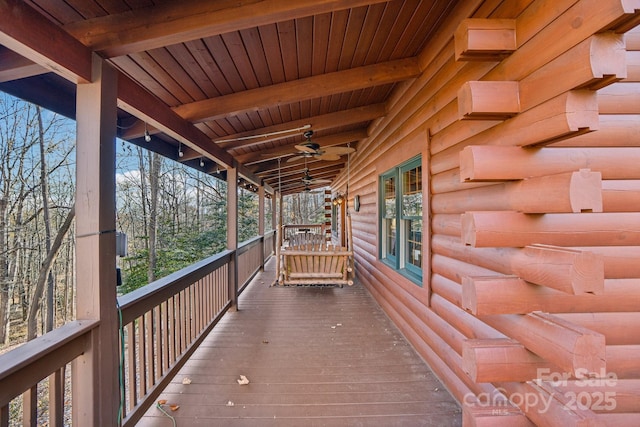 wooden terrace featuring ceiling fan and a porch