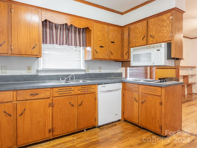 kitchen with crown molding, light wood-type flooring, white appliances, and sink