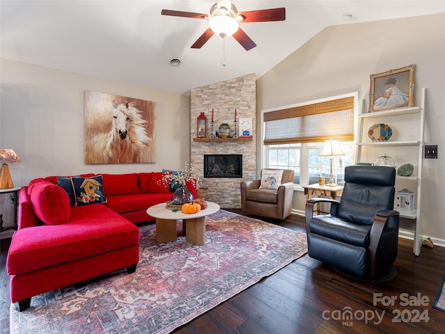 living room featuring hardwood / wood-style flooring, a stone fireplace, ceiling fan, and lofted ceiling