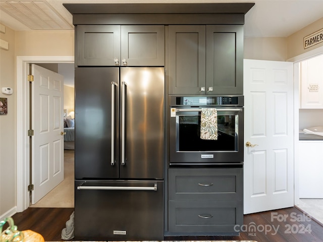 kitchen featuring dark hardwood / wood-style flooring and appliances with stainless steel finishes