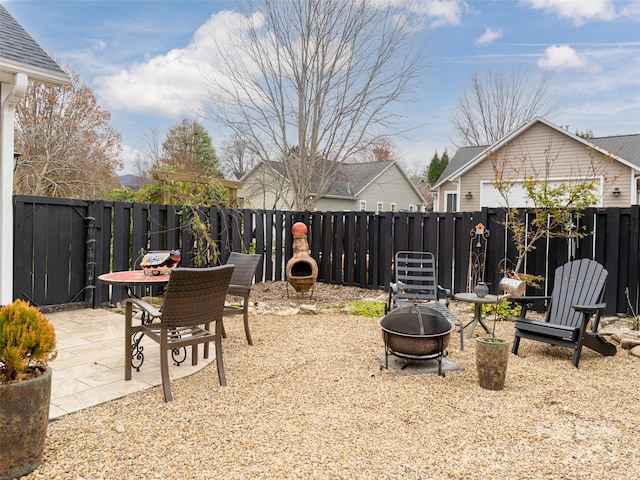 view of yard featuring a fire pit and a patio