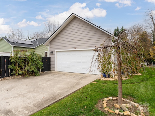 view of property exterior with solar panels and a garage