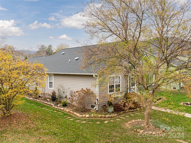 view of property exterior with a lawn