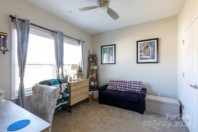 carpeted office space with ceiling fan