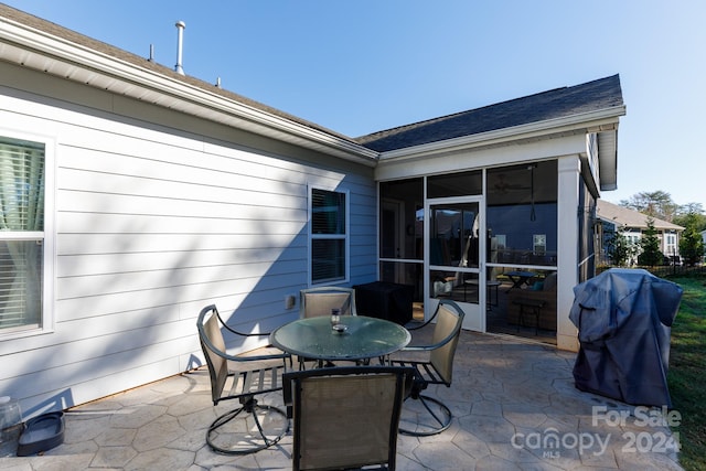 view of patio with a sunroom