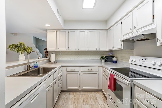 kitchen with white cabinetry, white appliances, sink, and backsplash