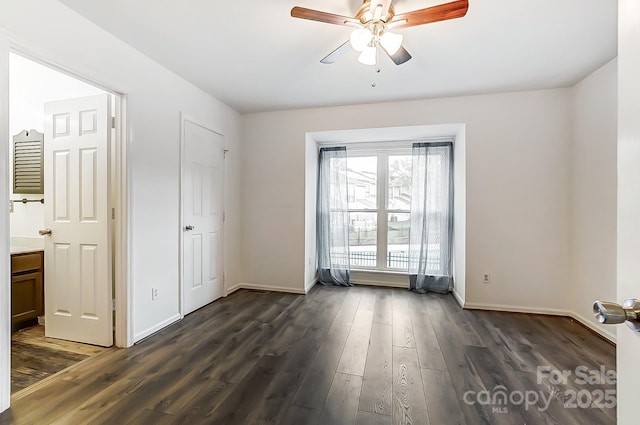 spare room featuring dark hardwood / wood-style floors and ceiling fan