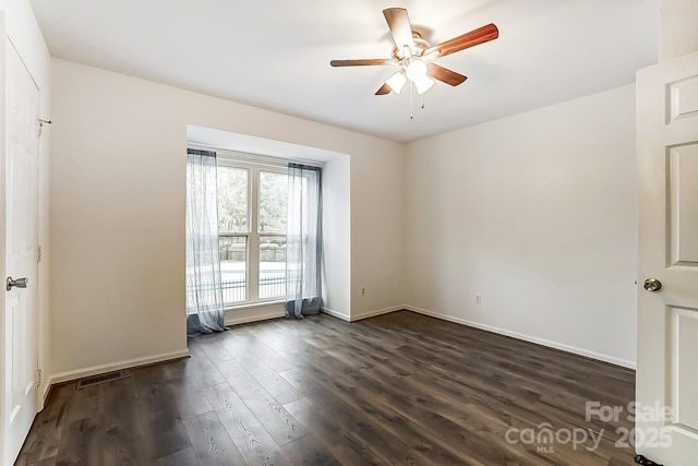 spare room featuring dark hardwood / wood-style flooring and ceiling fan