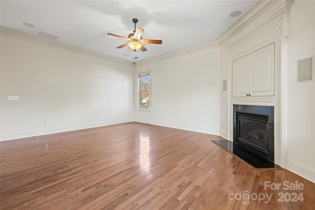 unfurnished living room with ceiling fan, wood-type flooring, and crown molding