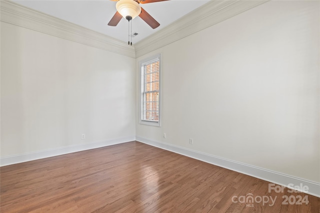 spare room with hardwood / wood-style floors, ceiling fan, and crown molding