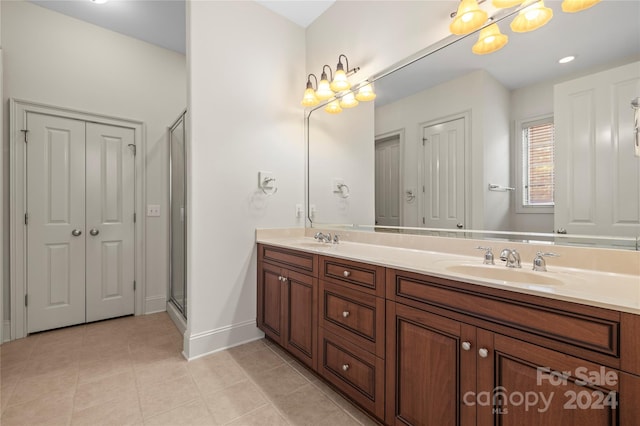 bathroom featuring tile patterned floors, vanity, and an enclosed shower