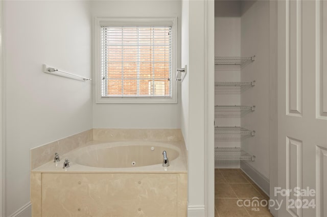 bathroom featuring tile patterned floors and a bathtub