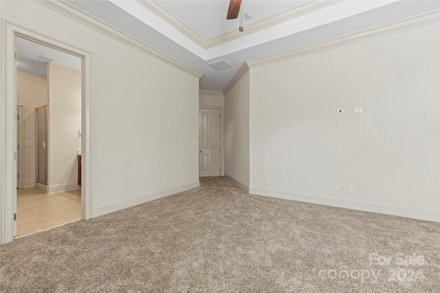 interior space with ceiling fan, ornamental molding, and light carpet