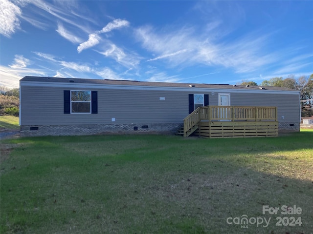 view of front of house featuring a deck and a front yard