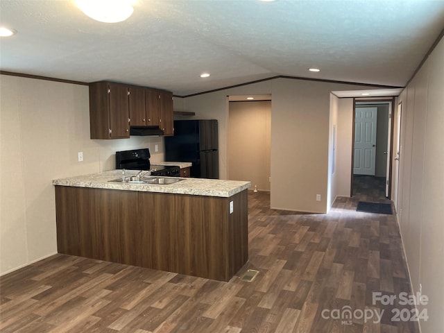 kitchen featuring sink, dark hardwood / wood-style flooring, kitchen peninsula, vaulted ceiling, and black appliances