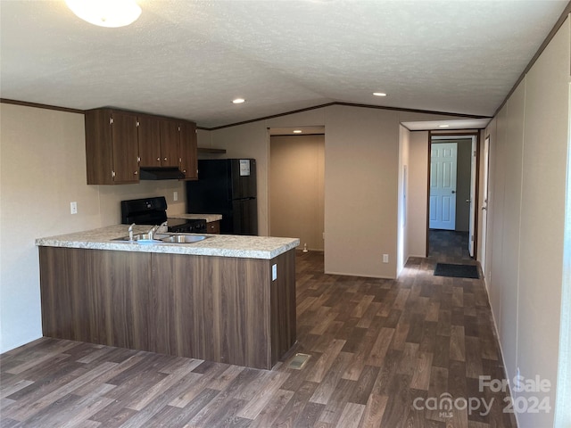 kitchen featuring kitchen peninsula, dark hardwood / wood-style flooring, and black appliances